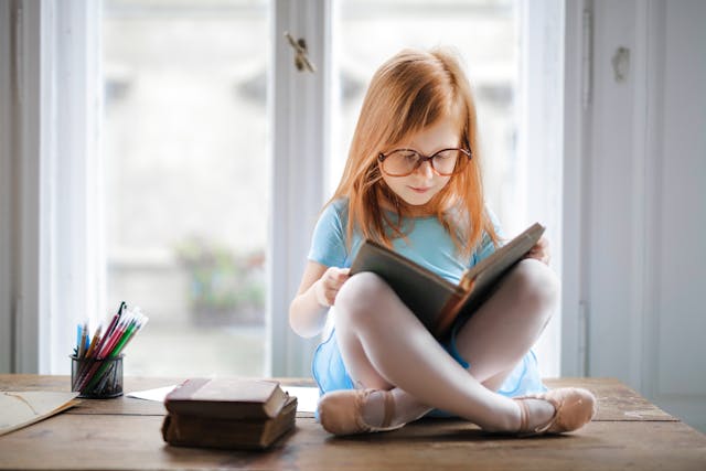 girl - red hair- reading a book